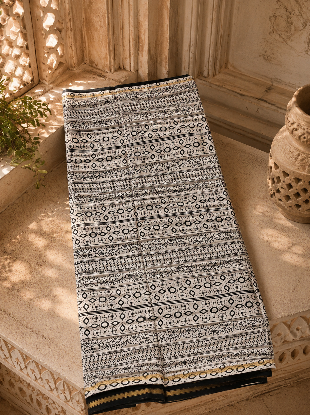Full view of handcrafted black Chanderi saree featuring a traditional zari border.