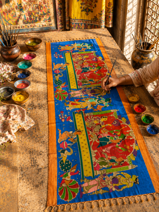 Handcrafted Kalamkari Mangalagiri silk dupatta being detailed by an Indian artisan using traditional painting techniques.