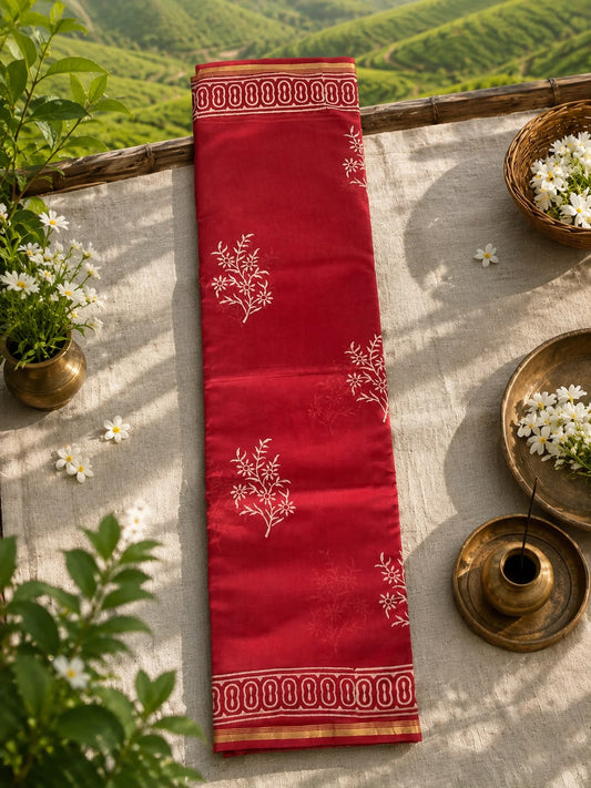 Premium red handwoven Chanderi saree displayed on a wooden hanger with floral block print detailing.