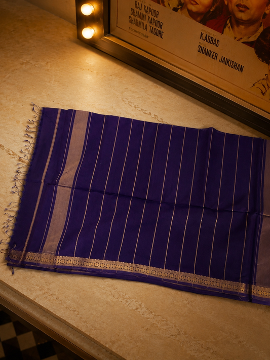 Close-up of handcrafted royal purple Chanderi saree highlighting luxurious gold zari woven border.
